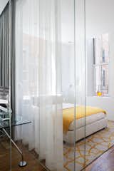 Tom Dixon Mirror Ball lights and a Flou Italia bed soak up sunlight in the guest room. 