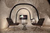 Living Room, Chair, Floor Lighting, End Tables, and Terrazzo Floor  Photos from A Primal Space Gets a Swanky, Modern Twist in This Turkish Cave Loft