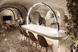 Dining Room, Table, Terrazzo Floor, Chair, Floor Lighting, and Accent Lighting  Photo 10 of 13 in A Primal Space Gets a Swanky, Modern Twist in This Turkish Cave Loft