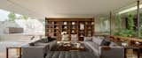 Living Room, Bench, Sofa, Coffee Tables, Bookcase, Chair, Console Tables, Shelves, and Medium Hardwood Floor  Photos from A Serene Home in Mexico Weaves Around Verdant Gardens
