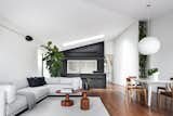Living, Coffee Tables, End Tables, Ceiling, Sofa, Accent, Chair, Table, Sectional, Wall, Rug, Pendant, and Medium Hardwood  Living Wall Medium Hardwood Rug Photos from Black Pivot Doors Frame Views of This Australian Home’s Verdant Garden