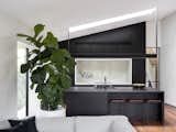 Kitchen, Stone Counter, and Undermount Sink  Photo 6 of 25 in Black Pivot Doors Frame Views of This Australian Home’s Verdant Garden