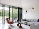Living, Sectional, Medium Hardwood, Sofa, Accent, Rug, Coffee Tables, Chair, End Tables, and Wall  Living Sectional Wall Sofa Photos from Black Pivot Doors Frame Views of This Australian Home’s Verdant Garden