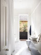 Bath, Marble, Ceramic Tile, One Piece, and Vessel  Bath Marble One Piece Photos from Black Pivot Doors Frame Views of This Australian Home’s Verdant Garden