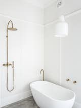 Bath Room, Ceramic Tile Floor, Open Shower, Accent Lighting, Freestanding Tub, and Ceiling Lighting  Photo 23 of 25 in Black Pivot Doors Frame Views of This Australian Home’s Verdant Garden