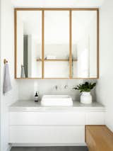 Bath Room, Marble Counter, Marble Wall, and Vessel Sink  Photos from Black Pivot Doors Frame Views of This Australian Home’s Verdant Garden
