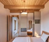 Bedroom, Bed, Night Stands, Light Hardwood Floor, Ceiling Lighting, and Pendant Lighting  Photos from Romantic Ruins Enclose a Modern House in the Czech Republic