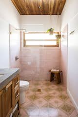 Bath Room, Ceramic Tile Floor, One Piece Toilet, Concrete Counter, Mosaic Tile Wall, Open Shower, and Undermount Sink The pink tiles in this bathroom were chosen to reflect the color of the sky at dusk.   Photo 17 of 30 in Casa Brumas by Diana Taylor