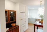 Kitchen, White Cabinet, Wood Cabinet, Pendant Lighting, Dishwasher, Medium Hardwood Floor, Colorful Cabinet, Recessed Lighting, Marble Counter, and Refrigerator  Photo 4 of 6 in Cozy Cottage in North Carolina by Kendis Charles