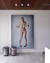 A floor-to-ceiling painting depicting a distressed naked woman in heels wrapped in luxury brand logos, was selected and curated by the homeowners.