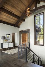 The smooth raw steel complements the textured exposed stone wall, oak floors and beetle kill pine ceiling—a rustic and contemporary mix found throughout the interior.