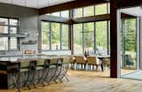 Large, aluminum-framed windows give the home a transparent, European feel.