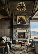 The interior design captures the abundant natural light, pairing a clean, streamlined layout with more rustic features, such as wooden beams and iron and bronze light fixtures.