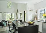 Kitchen, Engineered Quartz Counter, Ceiling Lighting, Dishwasher, Wall Oven, White Cabinet, Subway Tile Backsplashe, Concrete Floor, Ceramic Tile Backsplashe, Recessed Lighting, and Cooktops  Photo 3 of 5 in New by keegan burkett from Knoll House