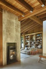 Living Room, Bench, Concrete Floor, Standard Layout Fireplace, Sofa, Medium Hardwood Floor, and Corner Fireplace  Photo 15 of 18 in Kayak Point by Christopher Wright Architecture