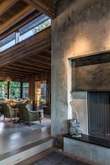 Living Room, Wood Burning Fireplace, Concrete Floor, Corner Fireplace, and Chair  Photo 4 of 18 in Kayak Point by Christopher Wright Architecture