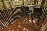 The deck overlooking the surrounding forest is made of locally milled black locust. The custom iron railing was done by Iron Maiden Studios, a metalshop in Asheville.&nbsp;