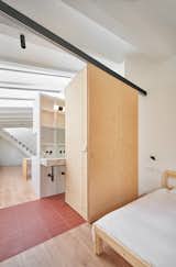 Bedroom, Track, Ceiling, Medium Hardwood, and Bed  Bedroom Track Photos from Picture Windows and Sliding Doors Work Magic in This Cozy Barcelona Home
