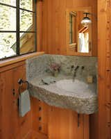 Bath Room, Concrete Counter, Medium Hardwood Floor, Wall Mount Sink, Wall Lighting, and Accent Lighting  Photos from A Rustic Home Rivals the Rugged Beauty of Its Forest Setting