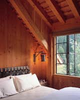 Bedroom, Bed, Night Stands, Accent Lighting, and Wall Lighting  Photos from A Rustic Home Rivals the Rugged Beauty of Its Forest Setting