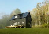 Architect Elizabeth Herrmann designed this 1,120-square-foot, gable-roofed cottage at the base of a bucolic hillside in Fayston, Vermont. The black-stained exterior morphs depending on the season. "It can sometimes be very like the textures and colors of its surroundings," Herrmann says. "The siding mimics tree bark and shadows, and sometimes blends into the woods. At other times, especially winter, the house really contrasts with the landscape’s snowy ground."