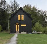 Close to Sugarbush’s Mount Ellen and the Mad River Glen ski area, Fayston, Vermont, is the prime setting for Little Black House. Giving the retreat its name, Elizabeth Herrmann Architecture + Design only had 1,120 square feet to work with. Sitting just below the top of a hill, the black-stained cabin flaunts a classic gable structure with a stripped-down interior melding white walls and pale wood floors.