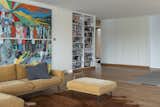 Living Room, Ottomans, Sectional, End Tables, Rug Floor, and Bookcase  Photos from An Architect’s Elevated Family Home Channels Mies van der Rohe on a German Lakefront