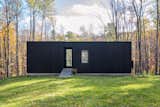 A Black Cabin Designed Like a Camera Frames the New England Countryside
