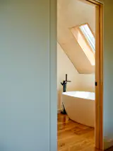 "The upstairs rooms are tucked up in the angled roof at the back and feel snug in a cool way,