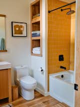 The floor throughout the home is white oak, and the yellow bath tile is from Heath in California.