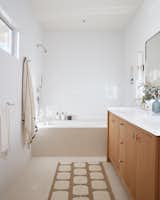The guest bathrooms feature a crisp white quartz, which is durable, easy to maintain, and needs no sealing.
