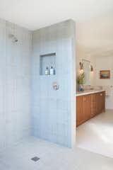 Like most of the house, the master bathroom sticks to neutral colors, warm browns, and a touch of delicate blue.