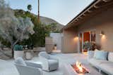 The swivel lounge chairs by the firepit are by Sutherland.