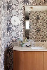 The powder room was white and bland before the renovation, and with very little natural light. Lunt decided to celebrate this moody room with a playfully retro wallcovering, that still has the muted colors of soft pinks and sage greens of the desert.