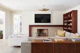 The fireplace had a faux stone facade under the mantel, which Lunt replaced with Heath Ceramics bowtie tile in a soft brown hue.