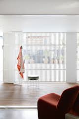 The downstairs guest suite has its own indoor/outdoor patio, protected by a slatted timber screen.