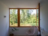 Every room in the back of the house has an amazing view of the Amsterdam Forest.  To take full advantage, HOP installed a large casement window in the two back-facing rooms upstairs. Robi and Christine kept the room's interior design to a minimum to accentuate the scenery.