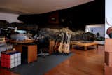 A giant Rubik's cube seems right at home in this bat cave sound studio.  The temperature in the studio is always cool, thanks in part to the thick walls and in part to the abundant lava rock.  Photo 14 of 14 in My House: The Live-In Studio of Lanzarote’s Beloved Artist Is Embedded Into Lava Rock