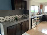 12. A well-equipped kitchen is a cook's dream with abundant cabinetry, spacious countertops and landscapes view