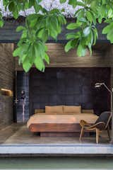 Bedroom, Ceiling Lighting, Bed, Concrete Floor, and Chair  Photo 15 of 16 in Am house by Creative Architects