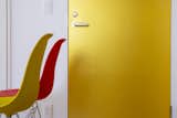 Office and Study Room Type Kitano House Renovation by 24d-studio large detail of gold door with yellow and red chairs in front of the door  Photo 4 of 10 in Kitano House Renovation by 24d-studio