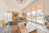 Living Room, Sofa, Pendant Lighting, Table, Ceiling Lighting, Concrete Floor, Coffee Tables, Storage, and Rug Floor  Photo 6 of 28 in House with a wallnut grove by Konkrét Stúdió