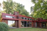 The Frank Lloyd-Wright inspired redwood home offers glass sliding doors facing the mountain view.