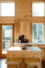 Kitchen, Wood Counter, Light Hardwood Floor, and Wood Cabinet Kitchen Island with floor to ceiling windows  Photo 8 of 32 in gatHER indie treehouse by Nikki McCall