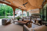 Spacious loggia with outdoor kitchen, towering ceilings, and custom brackets. 