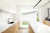 Kitchen, Engineered Quartz Counter, Porcelain Tile Backsplashe, Light Hardwood Floor, Wood Cabinet, White Cabinet, Undermount Sink, and Pendant Lighting Kitchen Window  Photo 14 of 42 in Pop goes the Young by Joanne Madeo