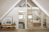 The upstairs loft is the perfect balance of work and play with a low platform bunk-bed set up and a full desk that overlooks the living space below.  Laurie Isenberg’s Saves from Budget Breakdown: A Bay Area Couple Turn an A-Frame Cabin Near Yosemite Into a $600-a-Night Rental