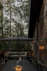 The front deck is a perfect extension of the indoor space divided in a dining and seating area. Green portable lamps via Hay have a low glow to keep the party going after the sun sets.