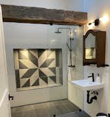 Accessible guest shower with tiled quilt motif reflecting Prince Edward County quilt design.