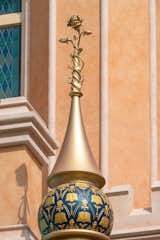 Colors used to represent Belle in her tower are blue and yellow, inspired by the dress she wears strolling through the village and her quintessential ball gown. The golden finial depicts the enchanted rose from Beast’s castle.

Photo: ©Disney